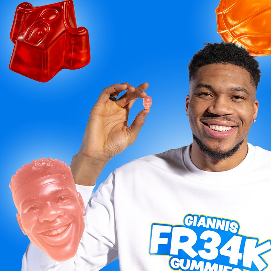 Man holding a gummy bear with a blue background and gummy bears shaped like faces and a basketball.